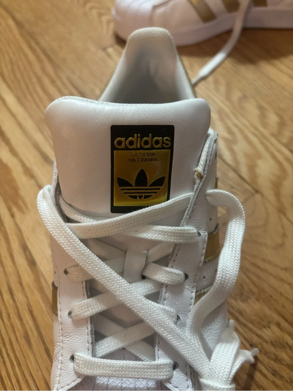 adidas Women's White Sneakers with Gold Stripe Accents